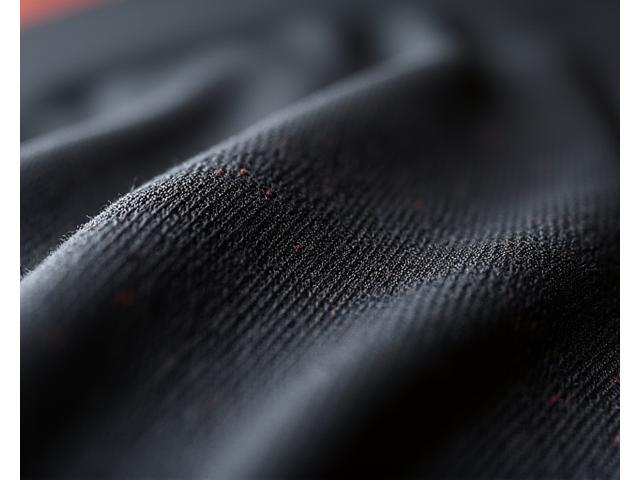 Close-up view of Zealot Athletics proprietary fabric showing textured, high-performance weave